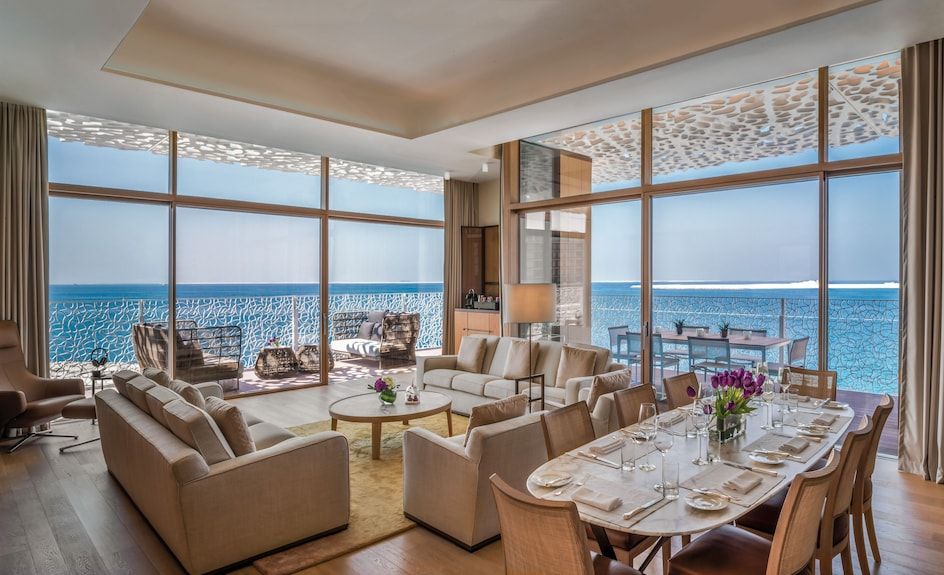 Dining table set by a sea-view window