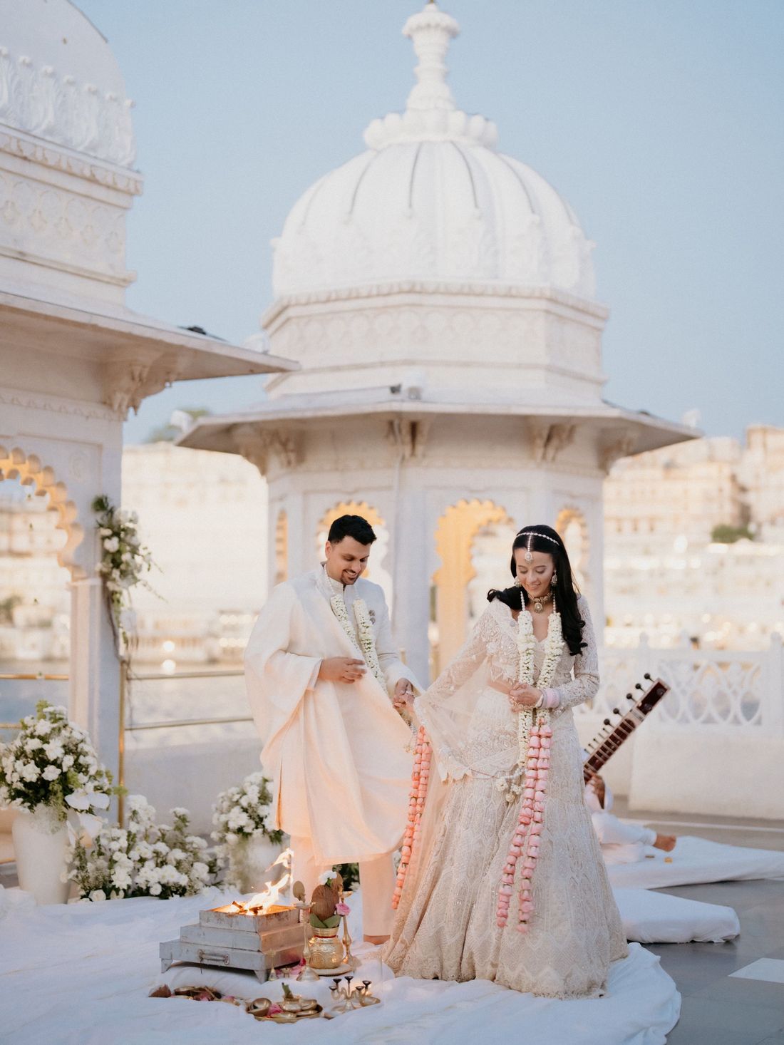 Couple during a wedding ceremony at a lakeside palace